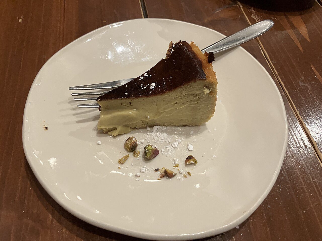 Pistachio Basque cheesecake slice, one of the trending cheesecake flavors of 2026